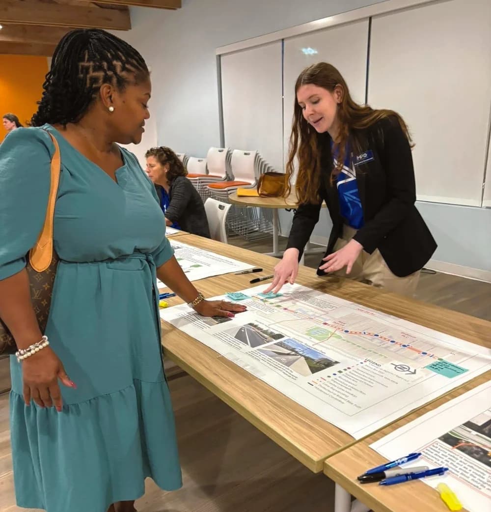 Dr. Mary Smith reviewing maps and plans at a community meeting